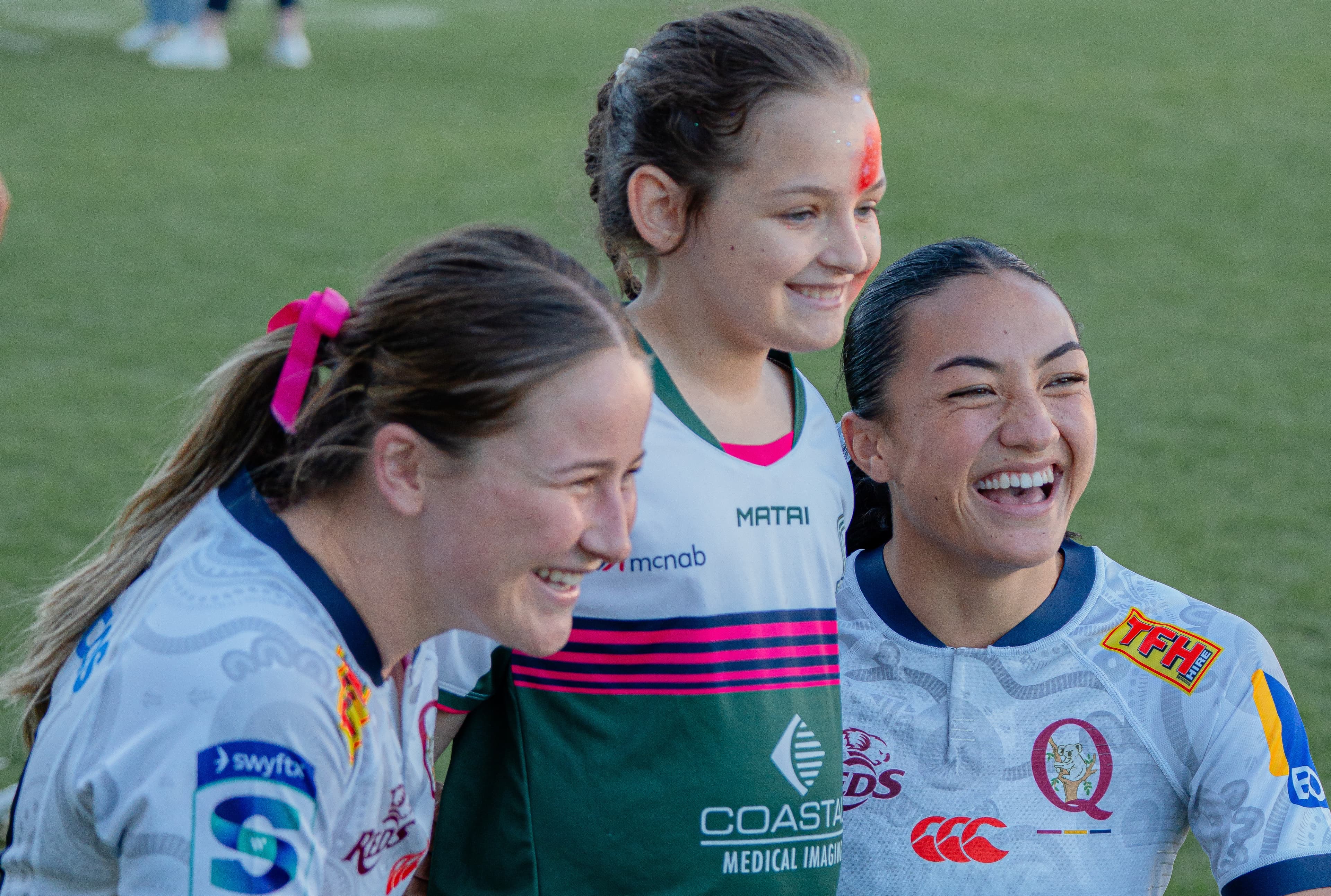 Fans on the Field at Ballymore is back...Reds duo Evie Sampson (left) and Kaelyn Passi (right) enjoy meeting a young fan after last weekend's trial against Fijian Drua