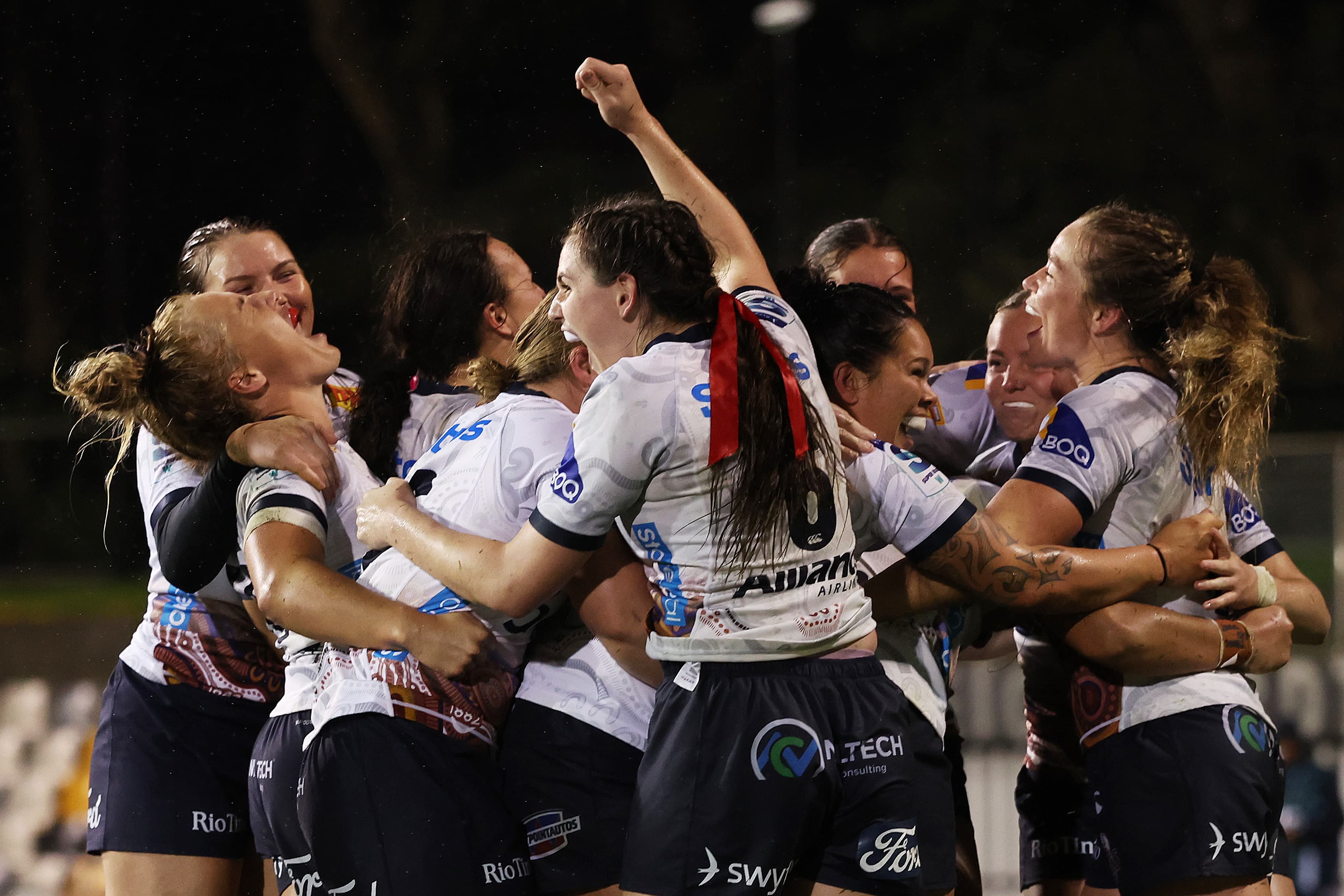 The Reds women's team celebrate beating NSW for the first time in Sydney today. Photos: Mark Metcalfe, Getty Images