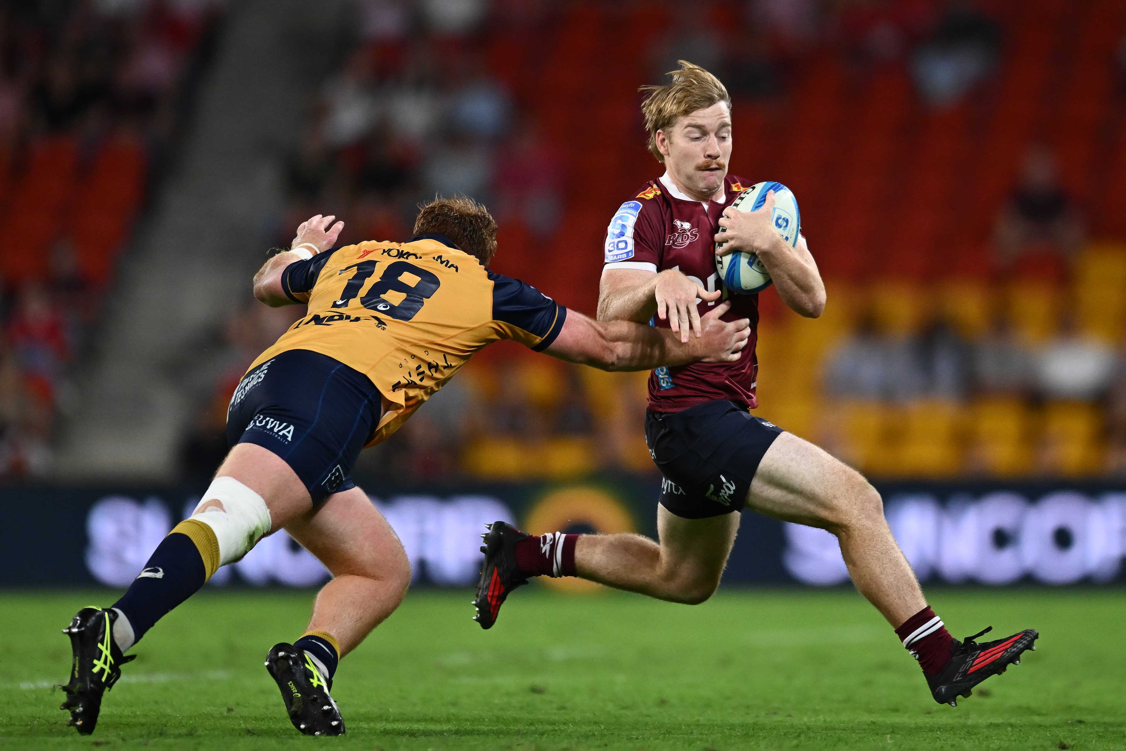 Replacement Reds flyhalf Harry McLaughlin-Phillips strains to evade the Force defence at Suncorp Stadium tonight. Photo: Albert Perez, Getty Images 