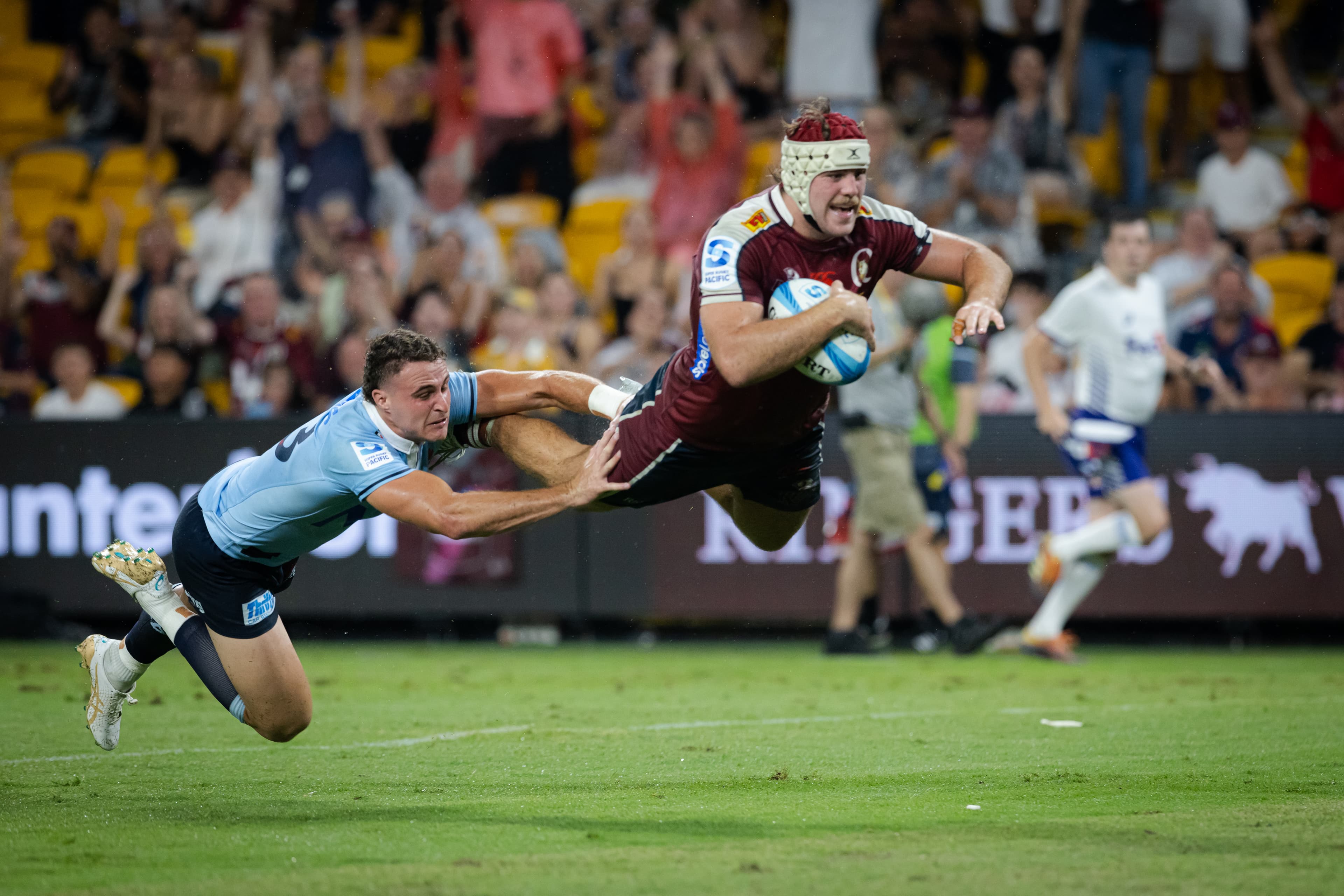 Reds flanker Fraser McReight flying high to the tryline against the Waratahs in 2024.