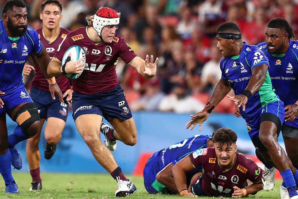Fraser McReight fending off Fijian Drua defenders at Suncorp Stadium. Photo: Getty Images