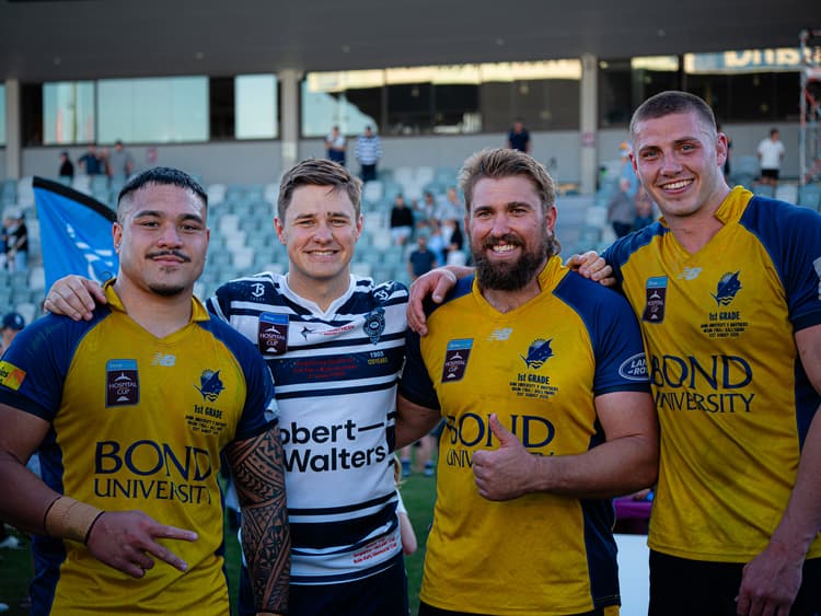 Reds at Bond University (from left) George Blake, Aidan Ross and Josh Canham celebrate while Brothers centre Josh Flook tries to hide the sting of grand final defeat