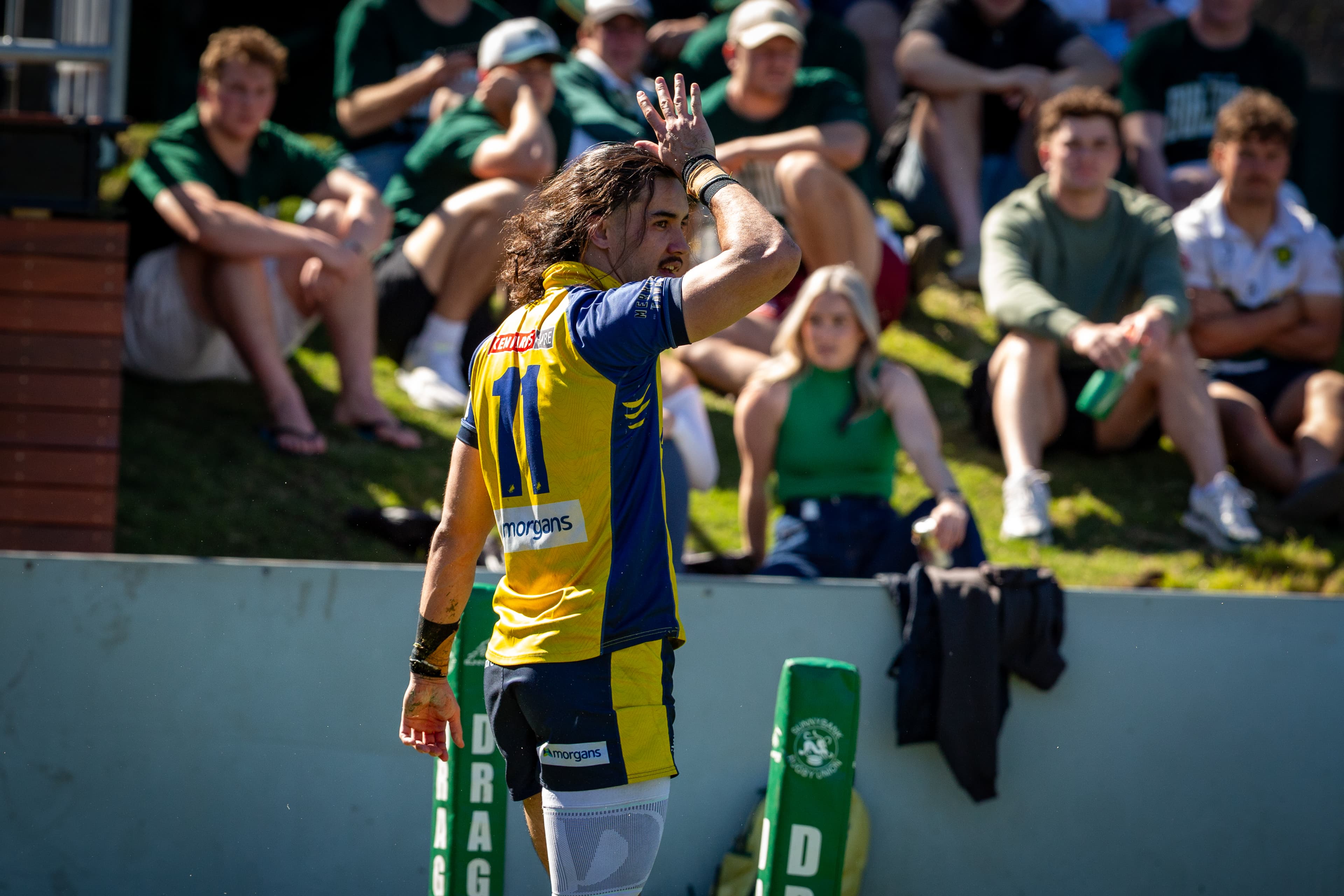 Bond University winger Deon Evans-Ao Leifi celebrates a fine try with a fins-up salute