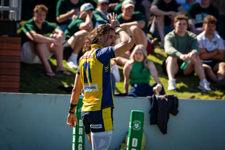 Bond University winger Deon Evans-Ao Leifi celebrates a fine try with a fins-up salute