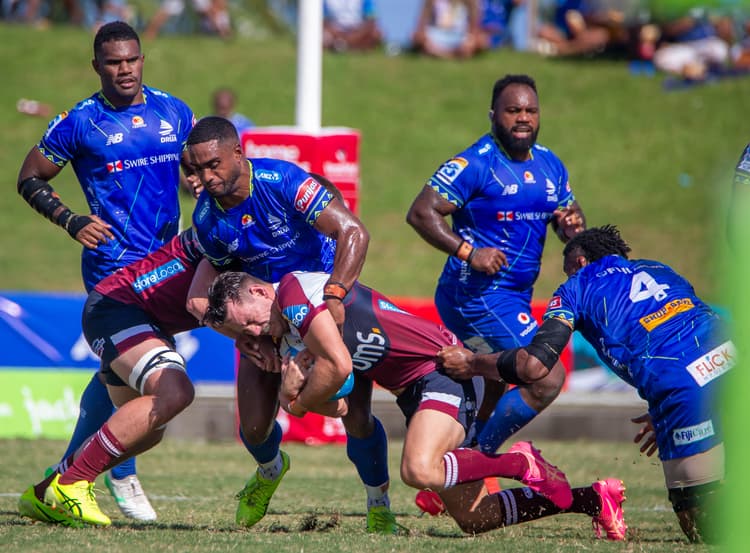 Reds winger Lachie Anderson is seized by the Fijian Drua defence in Suva