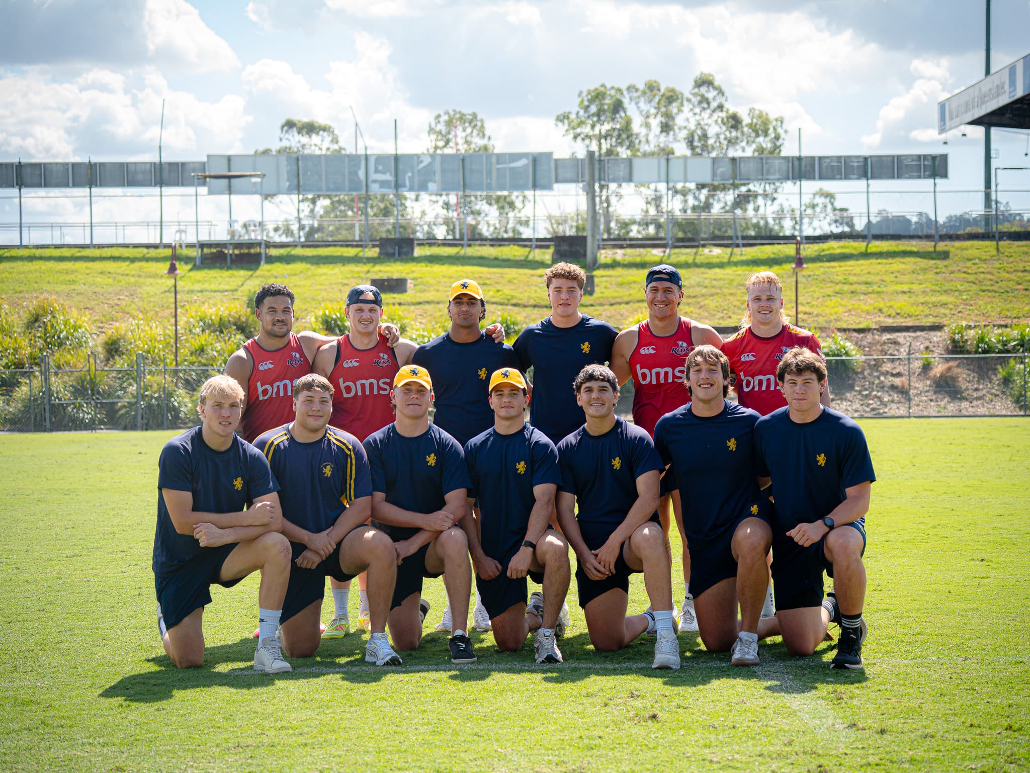 Reds (from left) Hunter Paisami, Tom Lynagh, Dre Pakeho and Louis Werchon mix with boys from Sydney's Scots College, who are in Brisbane for the Ballymore Cup