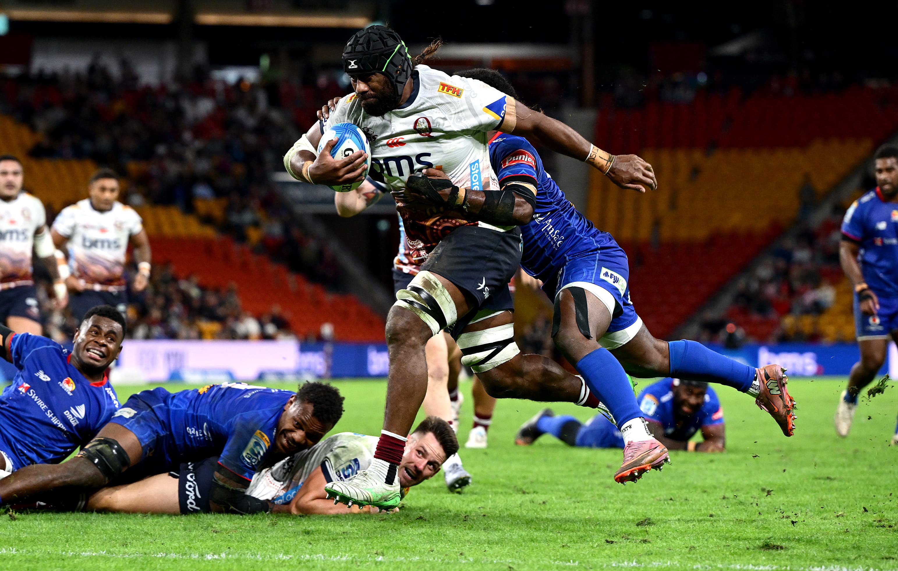 Reds flanker Seru Uru eyes off the tryline after taking a pass from Lachie Anderson (on ground) at Suncorp Stadium. Photo: Bradley Kanaris, Getty Images