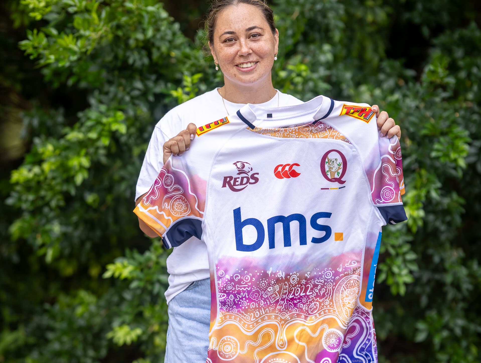 Jersey designer Madi Schuck proudly shows off the new Reds Indigenous jersey from Canterbury