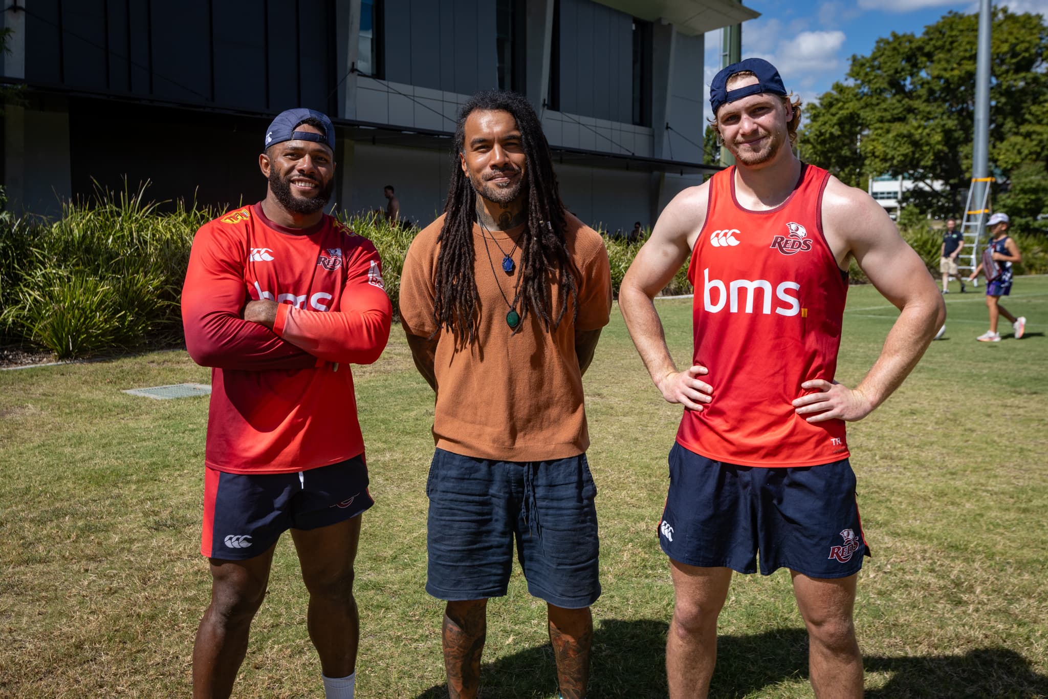 Reds wingers Filipo Daugunu and Tim Ryan catch up with 2011 Super Rugby champion Digby Ioane at training today