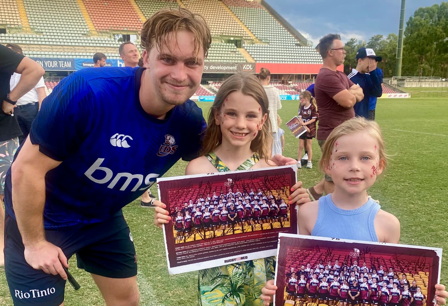 Winger Tim Ryan signing posters for young fans at the Reds' 2025 Open Training session