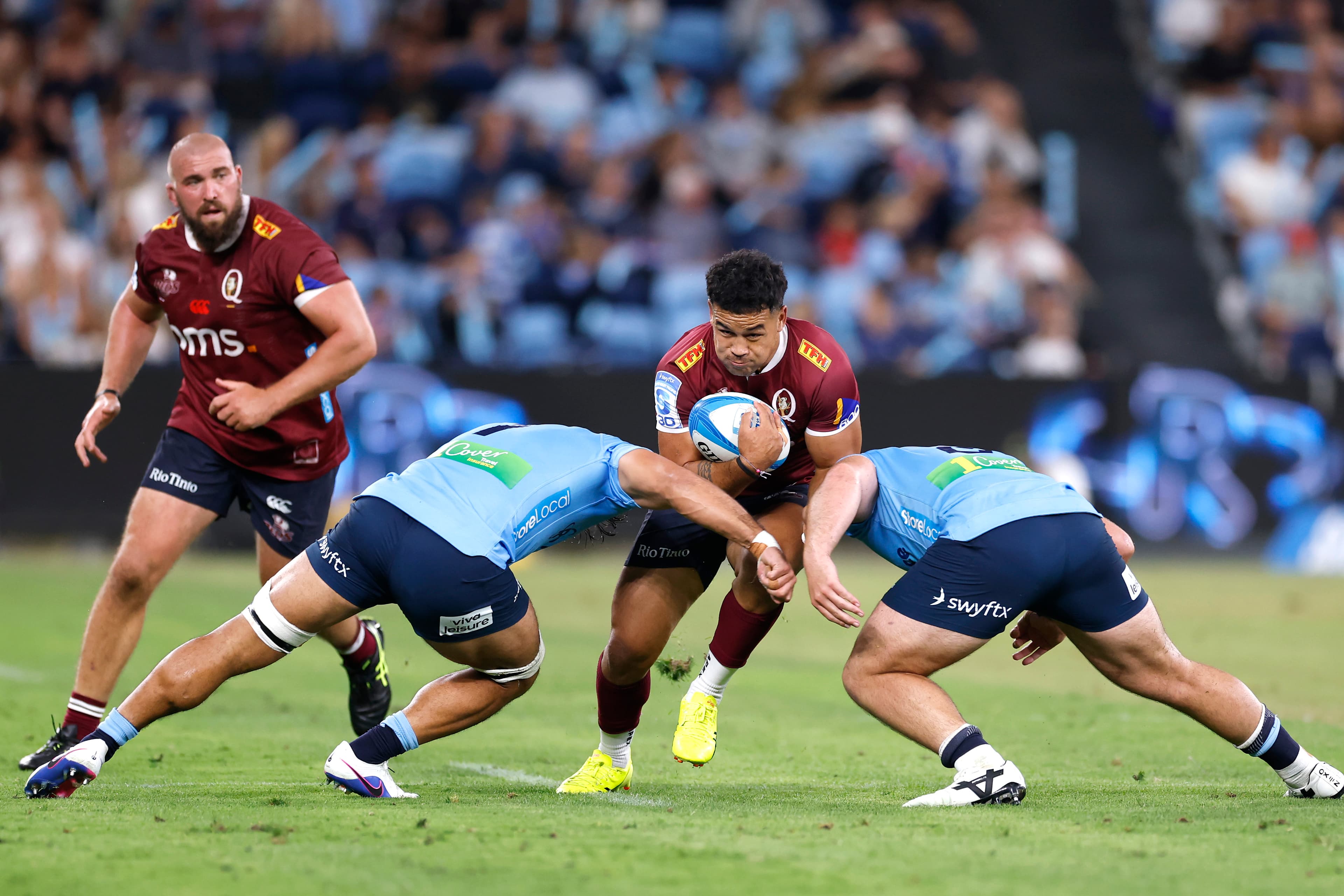 Reds centre Hunter Paisami charges at the Waratahs defence tonight in Sydney. Photos: Darrian Traynor, Getty Images