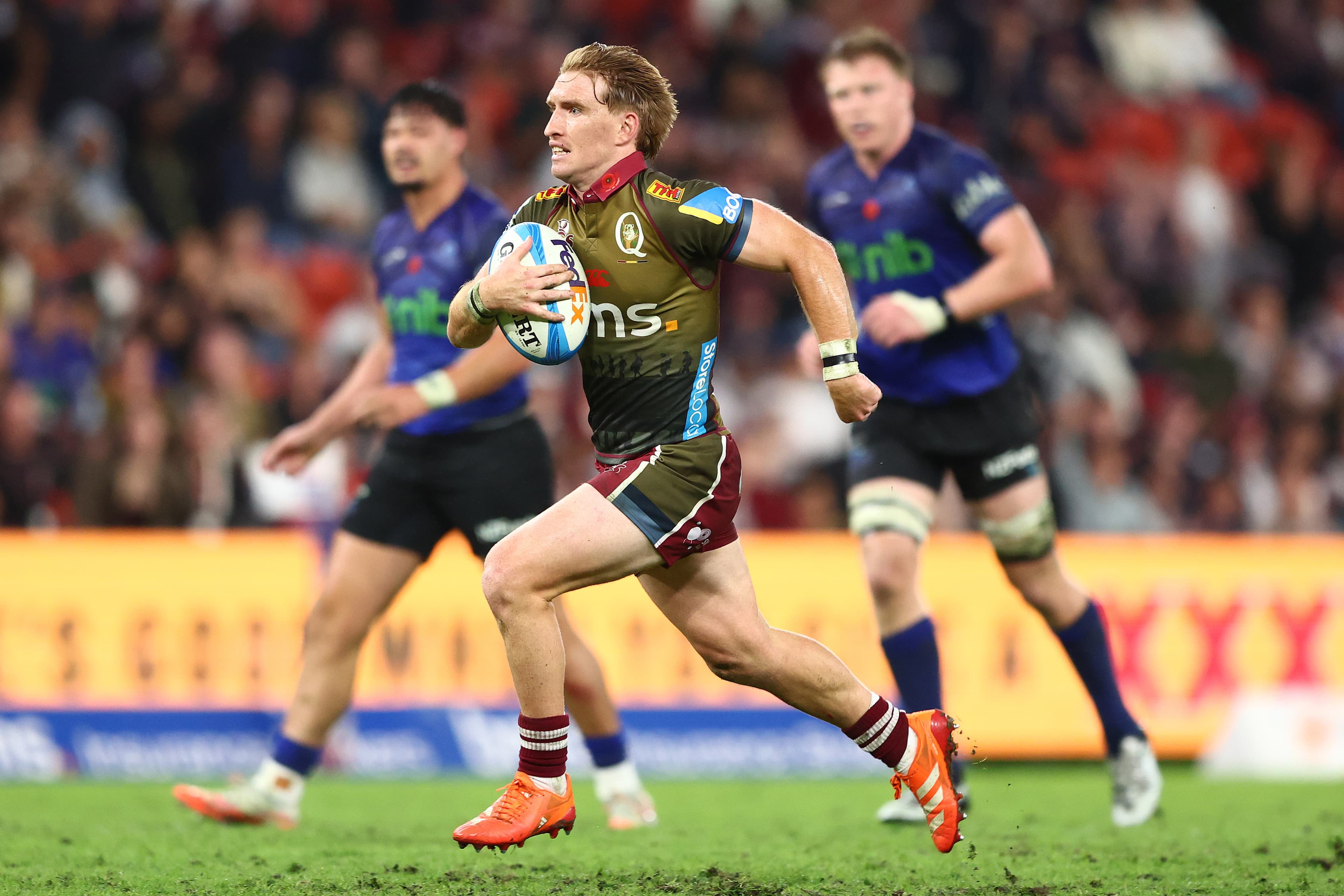 Tate McDermott races away to score during the Queensland Reds' win over the Blues on Anzac Day 2025. Picture: Getty