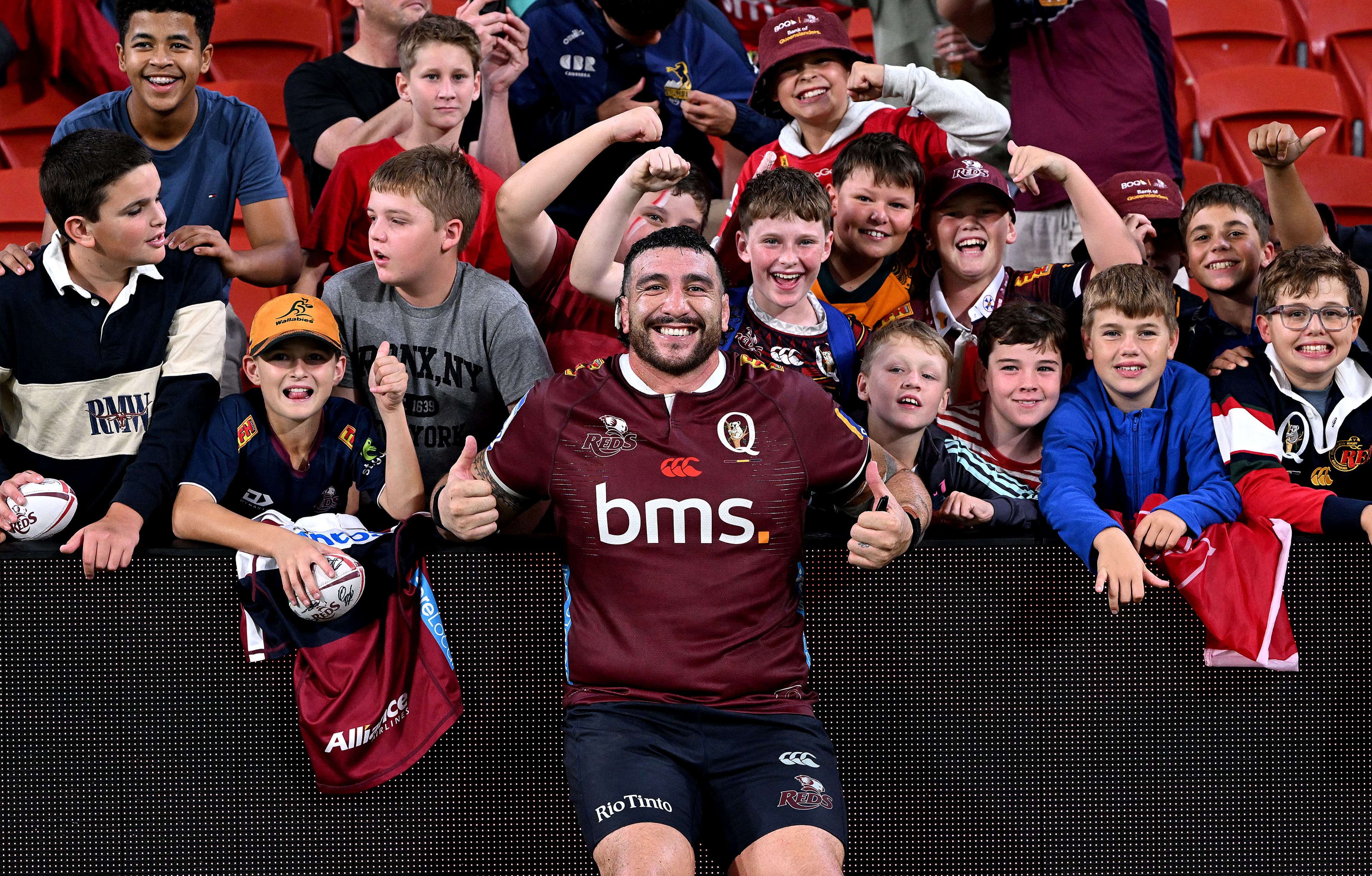 Young Reds fans from Churchie celebrate the win over the Brumbies with prop Jeffery Toomaga-Allen. Photo: Bradley Kanaris, Getty Images