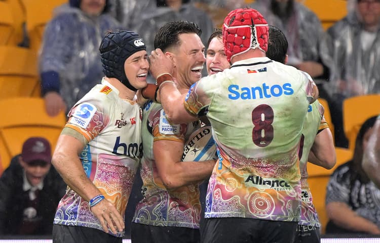 Try-scorer Lachie Anderson swamped by jubilant team-mates at Suncorp Stadium. Photo: Bradley Kanaris, Getty Images
