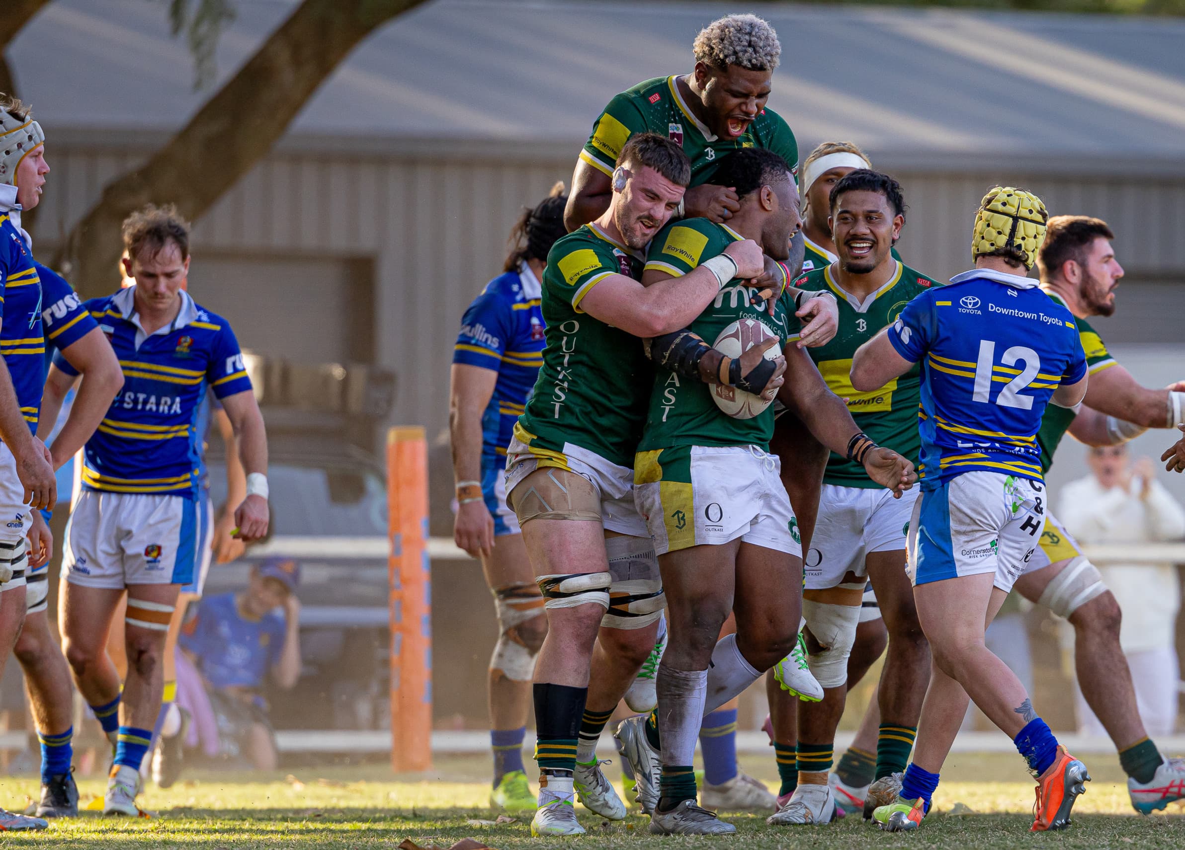 Teammates mob Wests tryscorer Isoa Tuwai in the semi-final against Easts