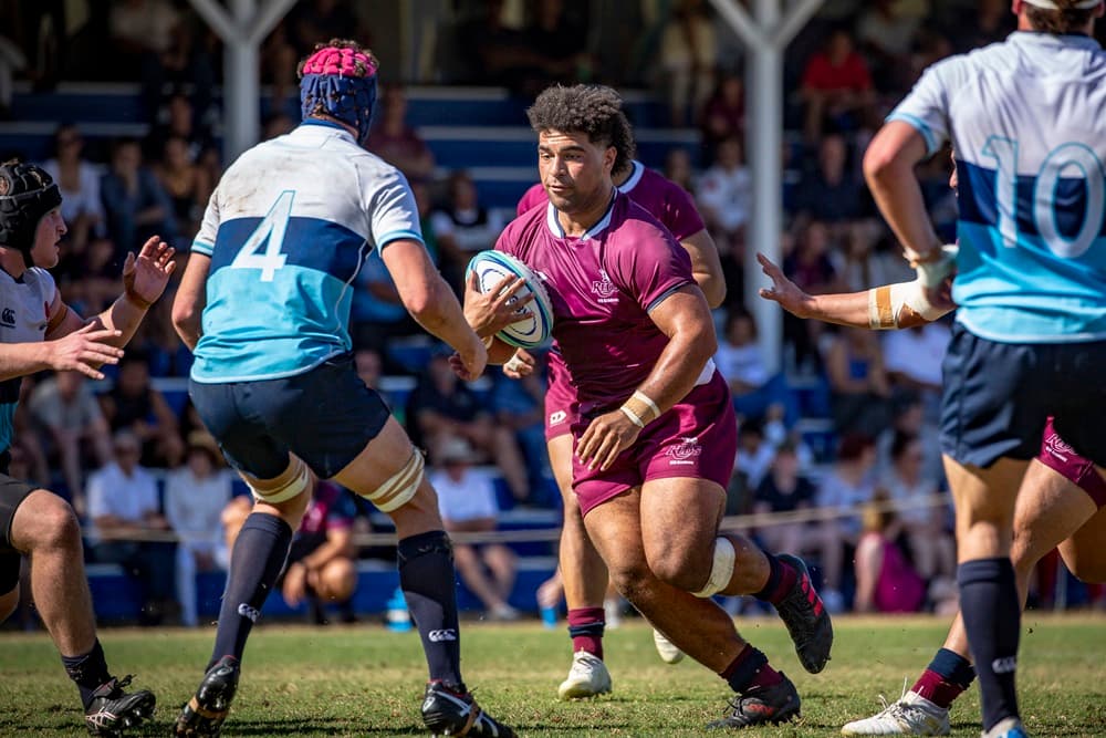 Zane Nonggor carries the ball for Reds Academy. Photo: Brendan Hertel/QRU