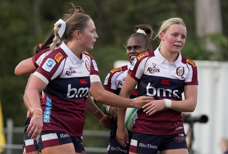 Tryscorer Piper Flynn (right) receives congratulations from teammate Carys Dallinger at Ballymore Stadium.