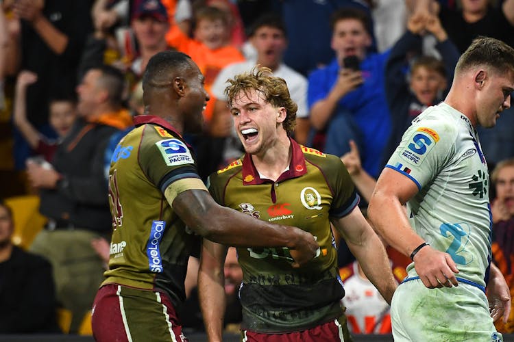 Tim Ryan of the Reds celebrates with Suliasi Vunivalu after scoring a try during the round 10 Super Rugby Pacific match between Queensland Reds and Blues at Suncorp Stadium